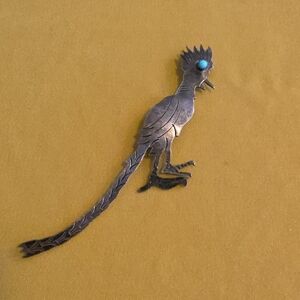 Vintage silver roadrunner brooch, often associated with Native American Jewelry